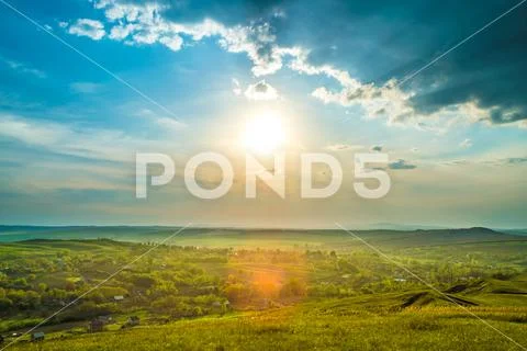 The picturesque field on the background of sunrise. Wide angle Stock Photos