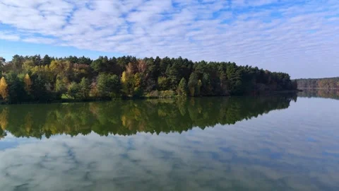Picturesque lake with reflection of forest under cloudy sky. Concept of beauty Stock Footage 291183954