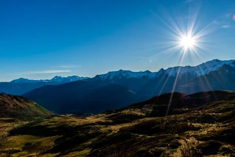 A picturesque landscape view of the fields in front of the snow capped French Stock Photos