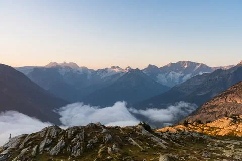 Picturesque mountain range with clouds rolling over mountain tops. Stock Photos