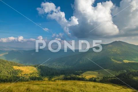 The picturesque mountain view on the background of cloud stream. Wide angle Stock Photos