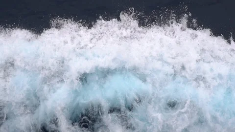 Picturesque ocean waves foam at ship bow on deep blue water Stock Footage