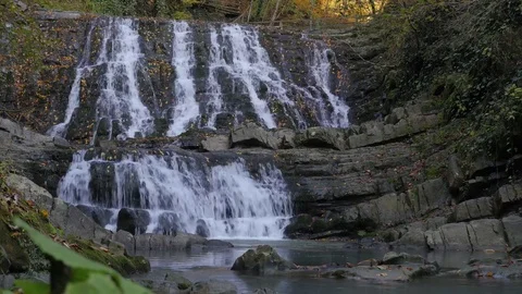 Picturesque overcast view of the stage waterfall in the autumn boxwood forest 4K Stock Footage 84493413