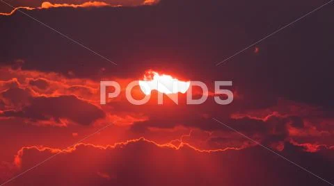 The picturesque red sunset with stormy clouds Stock Photos
