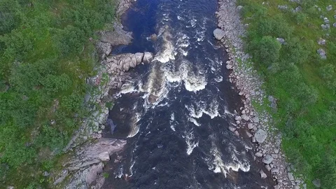 Picturesque river with stone rapids between green banks Stock Footage 116711406
