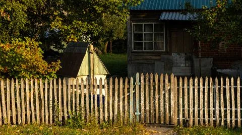 In a picturesque rural setting, a charming rustic home awaits, surrounded by  Stock Photos