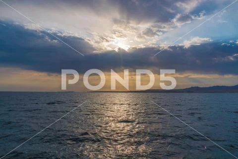 The picturesque sea view on the background of sunset Stock Photos