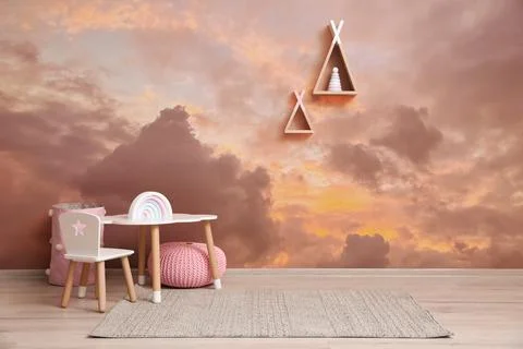Picturesque sky with clouds as wallpaper pattern. Baby room interior with t.. Stock Photos