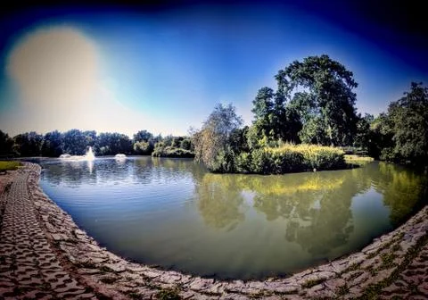 Picturesque small pond in which is reflected the blue sky Stock Illustration