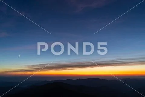 The picturesque sunrise above mountains. evening night time Stock Photos
