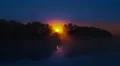 The picturesque sunrise (sunset) above forest near the lake 4k or 4k+ Resolution