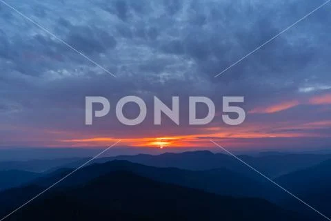 The picturesque sunset above mountain landscape Stock Photos