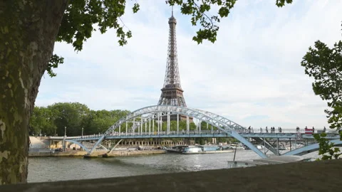 A picturesque view of the Eiffel Tower perfectly framed by a stone wall, green l Stock Footage 336363039