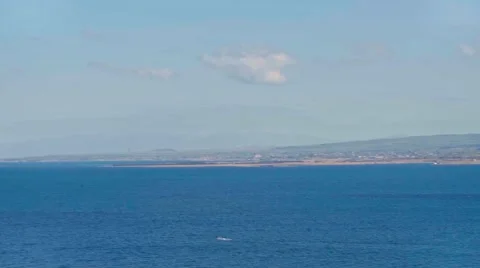 Picturesque view on lake Sevan and its shore on a sunny summer day Видео 65337191