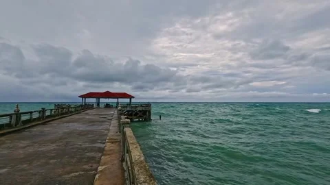 A picturesque view of a pier extending into tranquil ocean waters Stock Footage 311320008