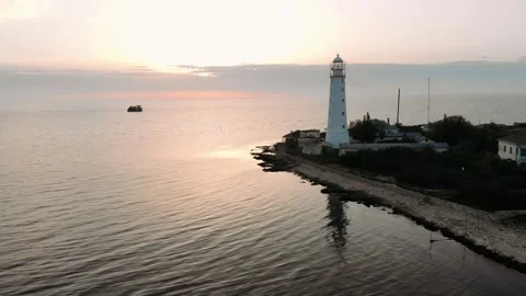Picturesque white lighthouse at the sunset. Navigation equipment on the sea. Stock Footage 162977311