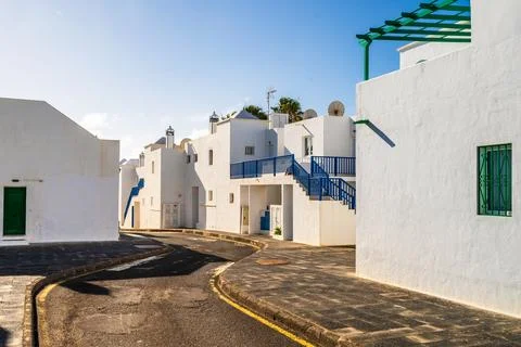 Picturesque whitewashed architecture with green elements in Costa Teguise, .. Stock Photos