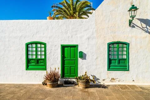 Picturesque whitewashed architecture with green elements in Costa Teguise, .. Stock Photos