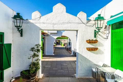 Picturesque whitewashed architecture with green elements in Costa Teguise, .. Stock Photos