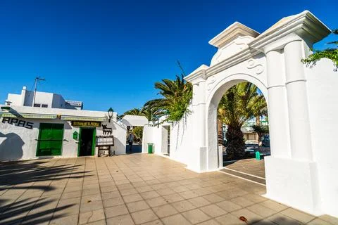 Picturesque whitewashed architecture with green elements in Costa Teguise, .. Stock Photos