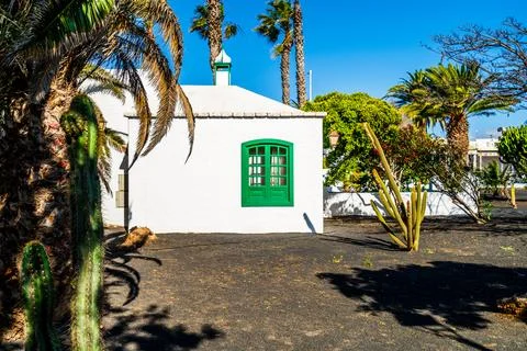 Picturesque whitewashed architecture with green elements in Costa Teguise, .. Stock Photos
