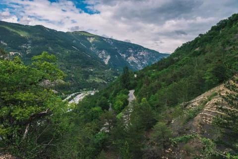 A picturesque wide panoramic view of an empty road in the valley of Var in th Stock Photos