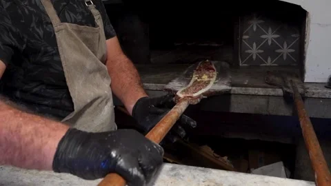 Pide Master Using Peel to Place Traditional Pide Dough into Stone Oven Stock Footage 323182928