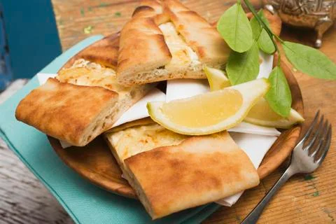 Pide (Turkish flatbread) with sheep's cheese filling Stock Photos