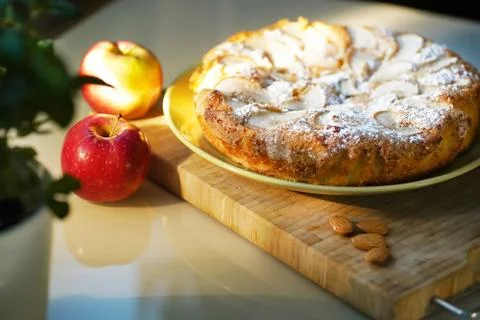 Pie with apples on a light table, almonds Stock Photos