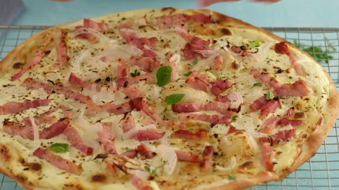 Pie with bacon, onion and sour cream. Flammkuchen. The woman made a German pie Stock Footage 138930290