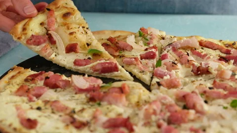 Pie with bacon, onion and sour cream. Flammkuchen. The woman made a German pie Stock Footage 138931043