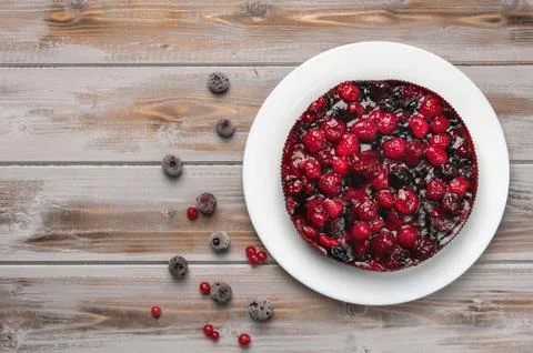 Pie with berries top view: raspberry, currant, strawberry on a white plate on a Stock Photos