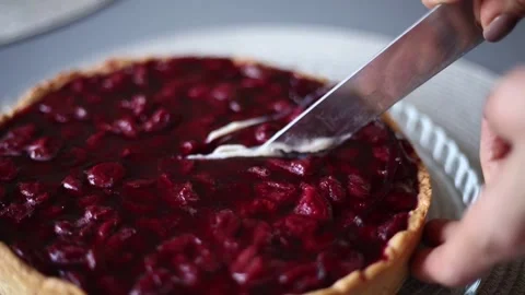 Pie with cherry filling is cut with a knife Stock Footage 172350596