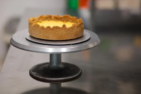 Pie crust for next lemon pie on cakestand in resort kitchen Fotos de archivo