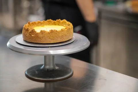 Pie crust for next lemon pie on cakestand in resort kitchen Fotos de archivo