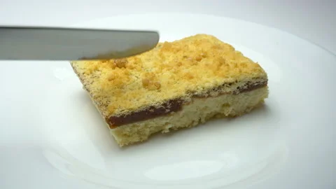 Pie is cutting by knife close up. White background Stock Footage 86767690