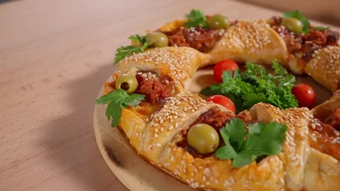Pie filled with potatoes and bacon on a wooden round board. Stock Footage 264141497