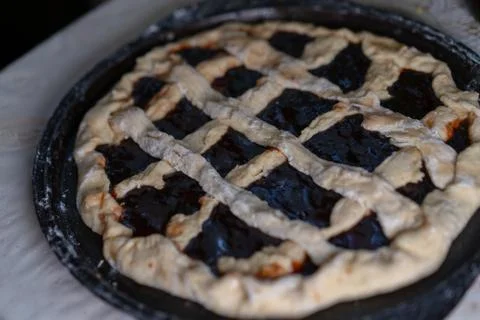 Pie with jam on a baking sheet before baking Stock Photos