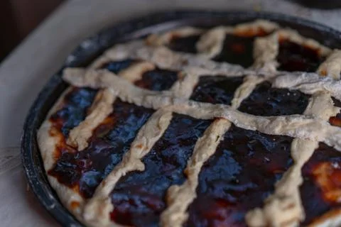 Pie with jam on a baking sheet before baking Stock Photos