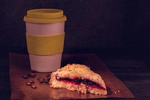 Pie with a mug of coffee on a dark background. retro style with grain Stock Photos