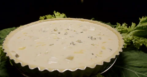 A Pie, Quiche, Being Prepared, Cooking, Seasoning, Pouring Cheese Slow Motion  Stock Footage 242437060