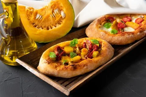 A pie with vegetables on a dark background. Breakfast is an appetizer. Stock Photos