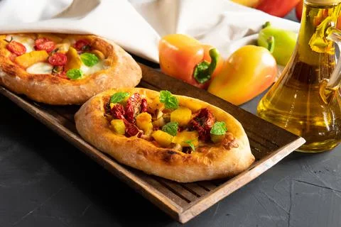 A pie with vegetables on a dark background. Breakfast is an appetizer. Stock Photos