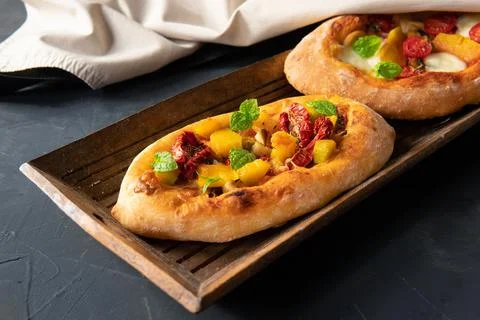 A pie with vegetables on a dark background. Breakfast is an appetizer. Stock Photos