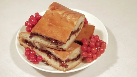 Pie with viburnum on a white plate Stock Footage 70330163