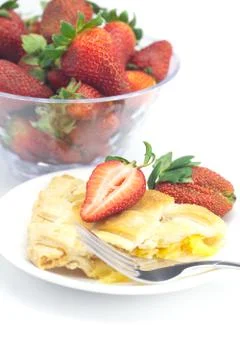 Piece of apple pie, fork and strawberries isolated on white Stock Photos