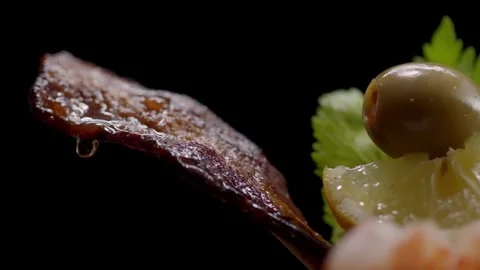 A piece of bacon drops grease hanging out of a drink Vidéo 253407562
