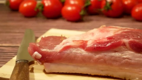 A piece of bacon with meat, sub meat, on a cutting board on the table Stock Footage 166641392