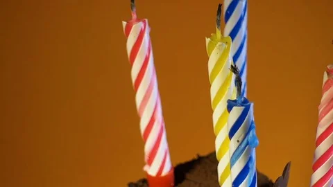 A piece of a birthday cake with five candles. Chocolate cupcake rotates on a  库存影片 85458486