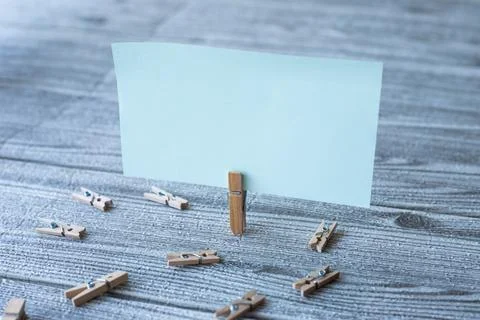 Piece Of Blank Square Note Surrounded By Laundry Clips Showing New Meaning... Stock Photos